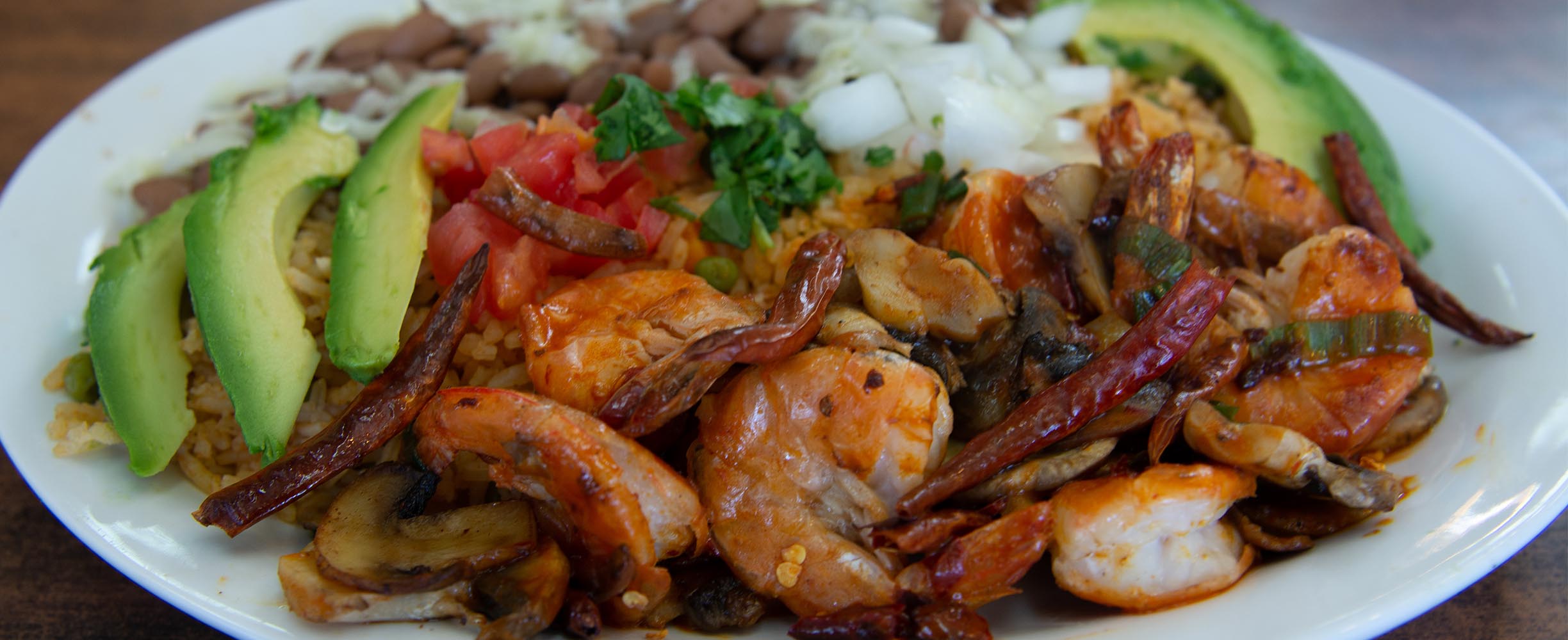 Mexican dish platter with shrimp, beef, chicken, avocado, beans and salad with delisious salsa in San Francisco
