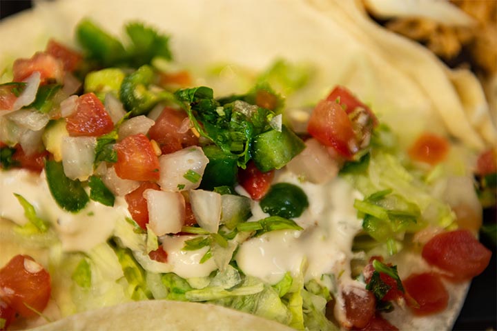 Tacos with cream and salsa.